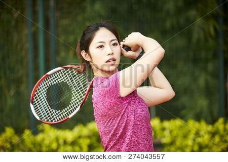 Young Asian Woman Female Tennis Player Hitting Ball With Forehand