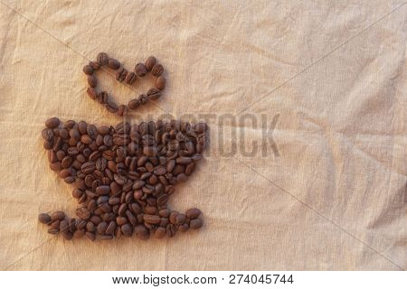 Image Of Cup And Heart Of Coffee Beans On Fabric.