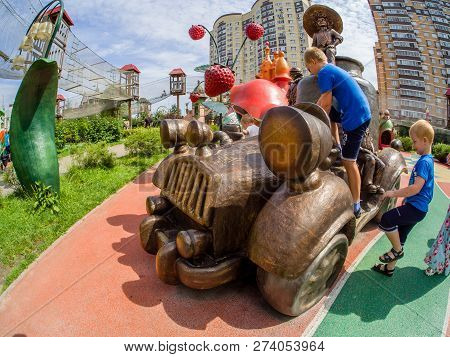 Moscow, Russia - July 26, 2018: Unidentified Boys Play With Car Playground Equipment In Children Amu