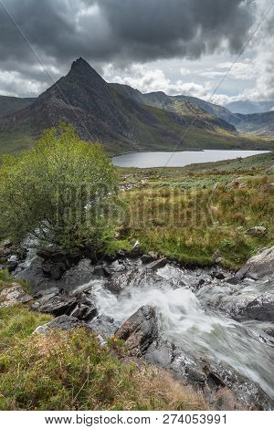 Beautiful Landscape Image Of Stream Near Llyn Ogwen In Snowdonia During Early Autumn Flowing Towards
