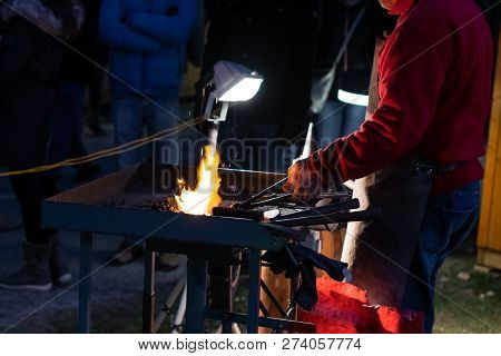A Craftsman Working With Fire And A Hammer On A Glowing Iron. Middle Age, Flame, Metal, Handmade;