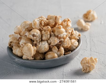 Popcorn In Gray Craft Trendy Plate On Gray Concrete Background. Moovie Background With Copy Space. T