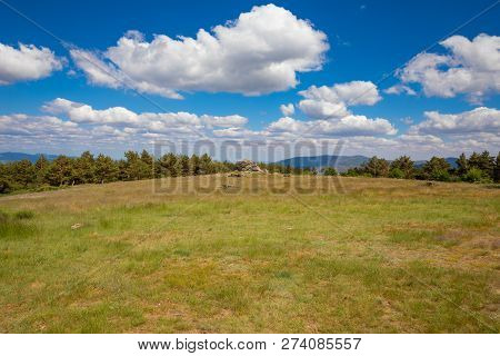 Landscape With Blue Sky Clouds And Grass Meadow In Navafria Near Madrid