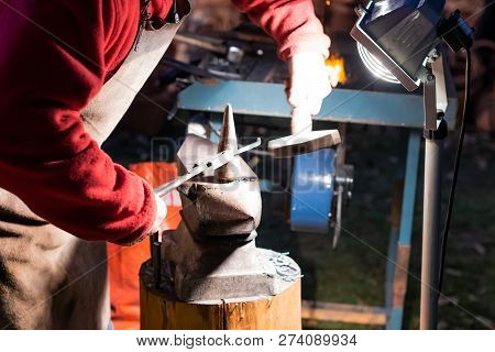 A Craftsman Working With Fire And A Hammer On A Glowing Iron. Middle Age, Flame, Metal, Handmade;