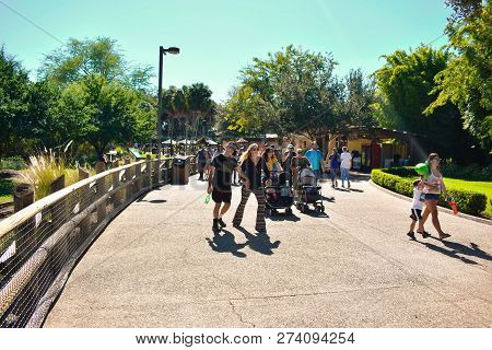 Tampa, Florida. October 25, 2018 People Walking At Evening In Park Street On Lightblue Sky Backgroun