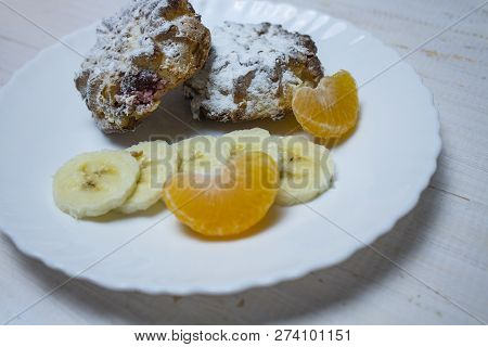 Cup Cakes With Raspberries And Nuts On A White Wooden Background. Tangerine Slice