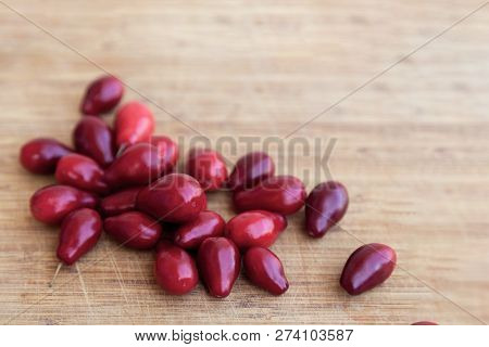 Bright Red Dogwood (cornel) On The Wooden Background. Close Up, Indoors, Copy Space.