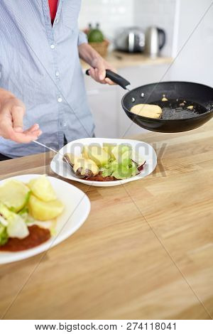 Female Hands, Black Frying Pan, Boiled Potatoes, Green Salad, Meat Cutlet With Cheese, White Ceramic