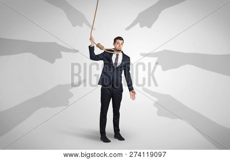 Young businessman trying to suicide with pointing hands concept