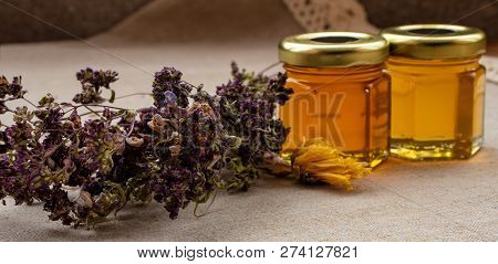 Honey From Different Flowers In Small Jars With Dried Summer Flowers.