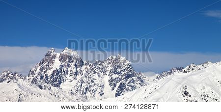 Panoramic View On Snowy Mountains And Blue Sky With Clouds At Sunny Winter Day. Caucasus Mountains. 