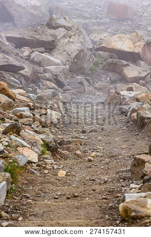 Vertica Harsh Stone And Graval Pathway For Hiking In Fog And Clouds