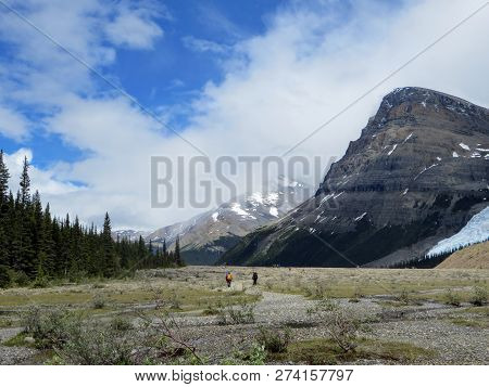 Hikers Hiking Along The Berg Lake Trail, In Mount Robson Provincial Park, British Columbia, Canada. 