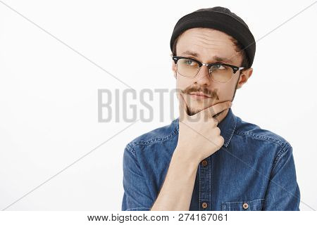 Thoughtful Smart And Creative Handsome Stylish Guy With Beard And Moustache In Black Beanie And Glas