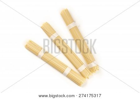 A Photo Of Three Individually Wrapped Portions Of Udon Noodles, Shot From The Top On A White Backgro