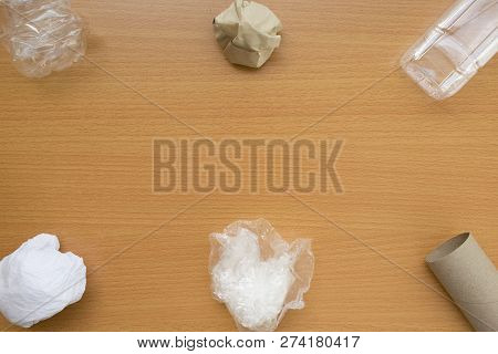 Top View Of Recycling Garbage Waste On Wooden Background With Center Copy Space , Eco And Save World