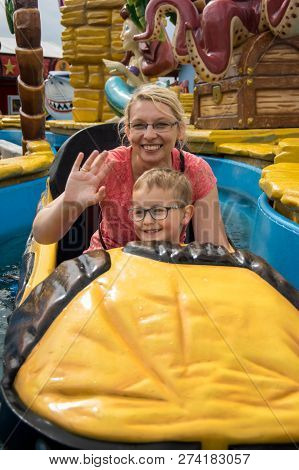 A Caucasian Mother And Her Son Enjoying At Amusment Park