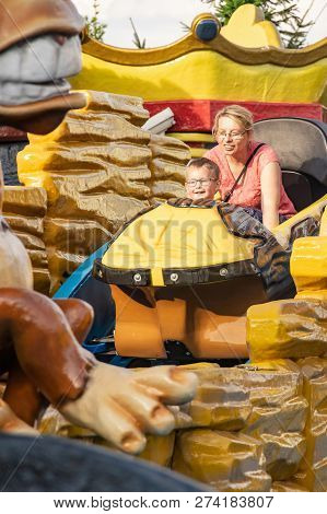 A Caucasian Mother And Her Son Enjoying At Amusment Park