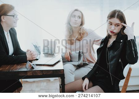 Upset Teenage Daughter In Jacket In Psychologist Office With Mother. Punk In Lather Jacket. Communic