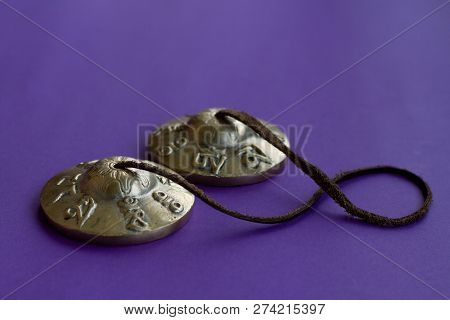 Tibetan Tingsha: A Musical Instrument With Eight Sacred Symbols Of Wealth And Well-being On The Body