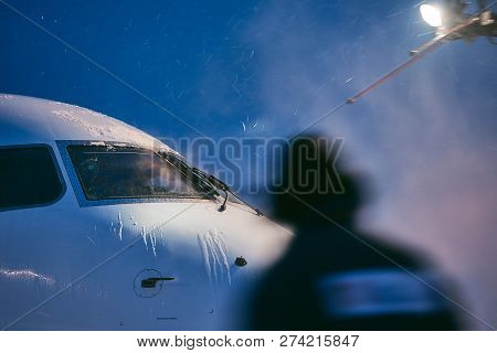 Winter Day At The Airport. Deicing Of Airplane Before Flight.