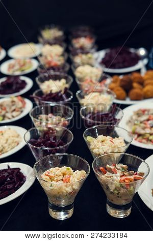 Small Salad Bowls With Salad On The Black Surface, Selective Focus