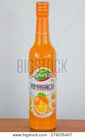 Pruszcz Gdanski, Poland - December 15, 2018: Lowicz Orange Juice In A Glass Bottle On Wooden Table.