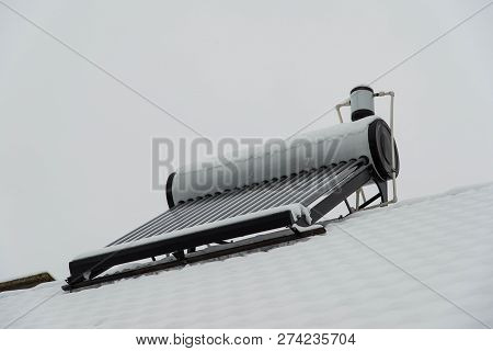 Empty Solar Water Heater Boiler On Residentual House Rooftop At A Cloudy Cold Winter Day.