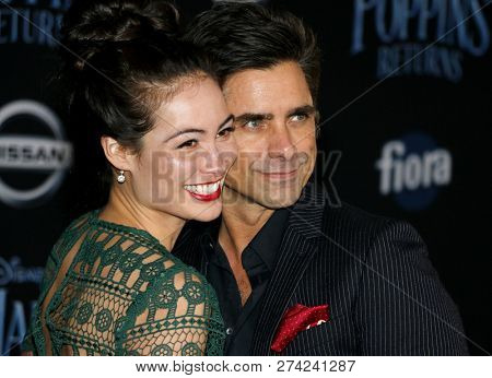 Caitlin Mchugh and John Stamos at the World premiere of Disney's 'Mary Poppins Returns' held at the Dolby Theatre in Hollywood, USA on November 29, 2018.