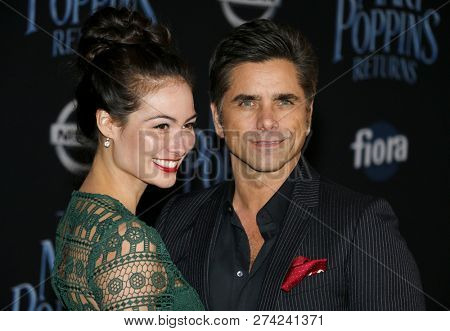 Caitlin Mchugh and John Stamos at the World premiere of Disney's 'Mary Poppins Returns' held at the Dolby Theatre in Hollywood, USA on November 29, 2018.