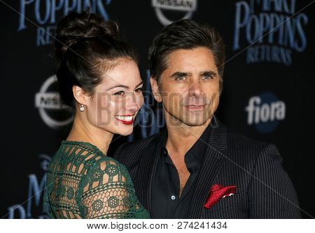 Caitlin Mchugh and John Stamos at the World premiere of Disney's 'Mary Poppins Returns' held at the Dolby Theatre in Hollywood, USA on November 29, 2018.