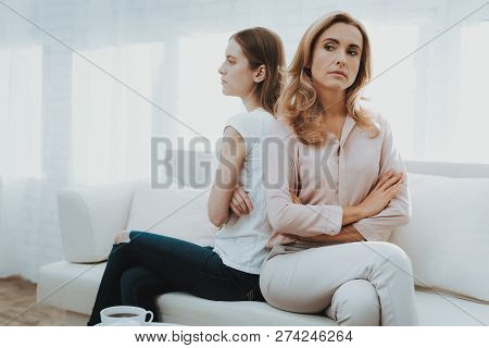 Woman Comforts Unhappy Teenage Daughter At Home. Sitting At Home On Couch. Girl With Problem. Confli