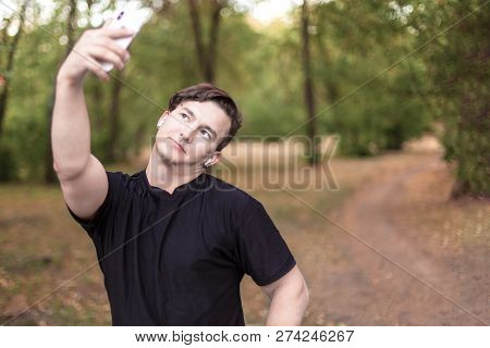 Close Up Portrait Of Attractive Young Caucasian Man With Dark Hair Making Selfie On Mobile Phone In 