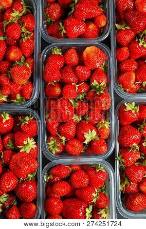 Close Up Of Fresh Red Ripe Strawberries In Transparent Plastic Container Boxes On Retail Market Disp