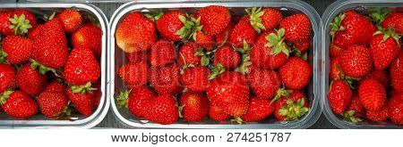 Close Up Of Fresh Red Ripe Strawberries In Transparent Plastic Container Boxes On Retail Market Disp