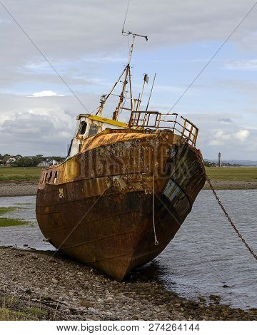 A Rusty Old Boat Moored Up In A Harbour