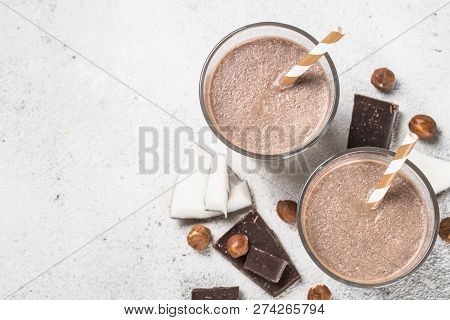 Chocolate Coconut Hazelnut Milkshake Or Smoothie In Two Glasses On White Table. Top View With Copy S