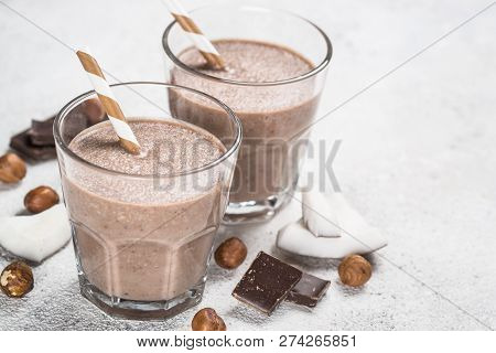 Chocolate Coconut Hazelnut Milkshake Or Smoothie In Two Glasses On White Table.