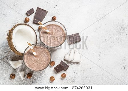 Chocolate Coconut Hazelnut Milkshake Or Smoothie In Two Glasses On White Table. Top View With Copy S
