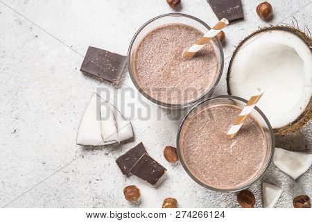 Chocolate Coconut Hazelnut Milkshake Or Smoothie In Two Glasses On White Table. Top View With Copy S