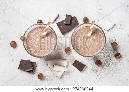 Chocolate Coconut Hazelnut Milkshake Or Smoothie In Two Glasses On White Table. Top View.