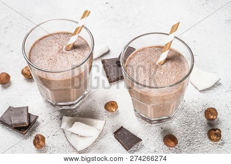 Chocolate Coconut Hazelnut Milkshake Or Smoothie In Two Glasses On White Table. Close Up.