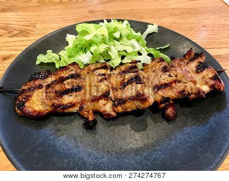 Lamb Meat Shashlik Kebab With Wooden Skewers In Black Plate / Saslik. Traditional Organic Food.