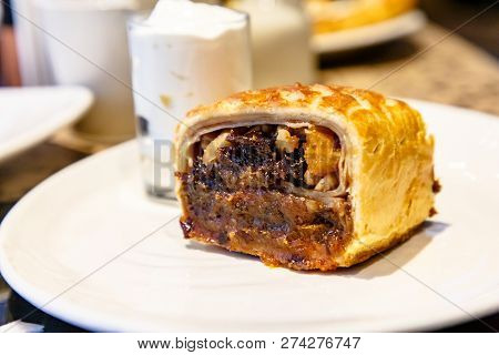 Strudel With Prunes, Dried Apricots And Nuts Lying On A Plate.