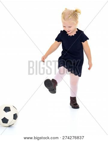Adorable Little Girl With A Soccer Ball. The Concept Of Childrens Sports, Summer Outdoor Recreation.