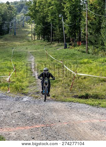 Bromont, Quebec - September 1, 2018 - Vertical Of A Colorful Dirt Bike Racers Competing On A Ski Hil