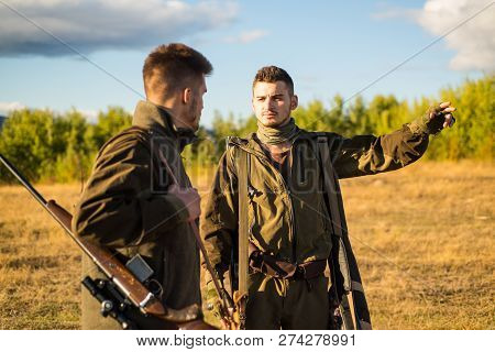 Hunter With Shotgun Gun On Hunt. Hunting In Spring Forest