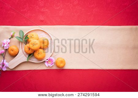 Orange Fruit, Pink Cherry Blossom With Copy Space For Text On Red Texture Background, Chinese New Ye