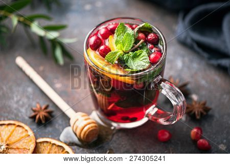 Hot Spiced Cranberry Tea With Cinnamon, Orange Peel, Star Anise And Honey In Glass Cup