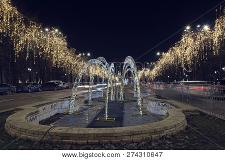 13 Dec 2018, Romania, Bucharest. Bulevardul Unirii Christmas Lights, Fountain And Traffic In Front O